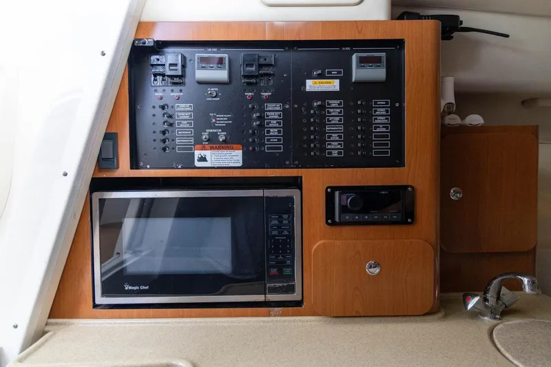 Slide: The Image of Control panel and microwave in 2006 Hydra-Sports Vector 3300 VX boat interior. - 27
