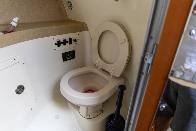 Slide: The Image of 2006 Hydra-Sports Vector 3300 VX boat bathroom with toilet and control panel. - 29