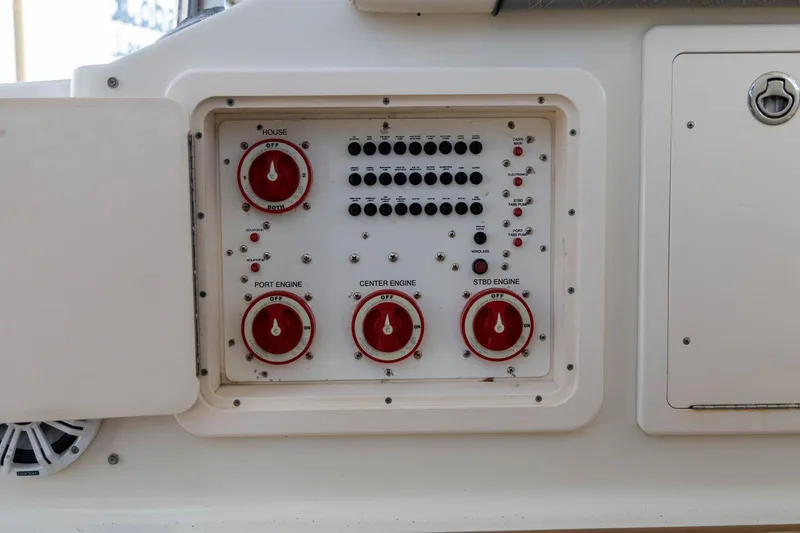 Slide: The Image of Control panel of a 2006 Hydra-Sports Vector 3300 VX boat, featuring engine switches. - 35