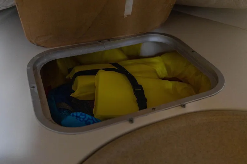 Slide: The Image of Storage compartment with yellow life jackets on a 2006 Hydra-Sports Vector 3300 VX boat. - 36