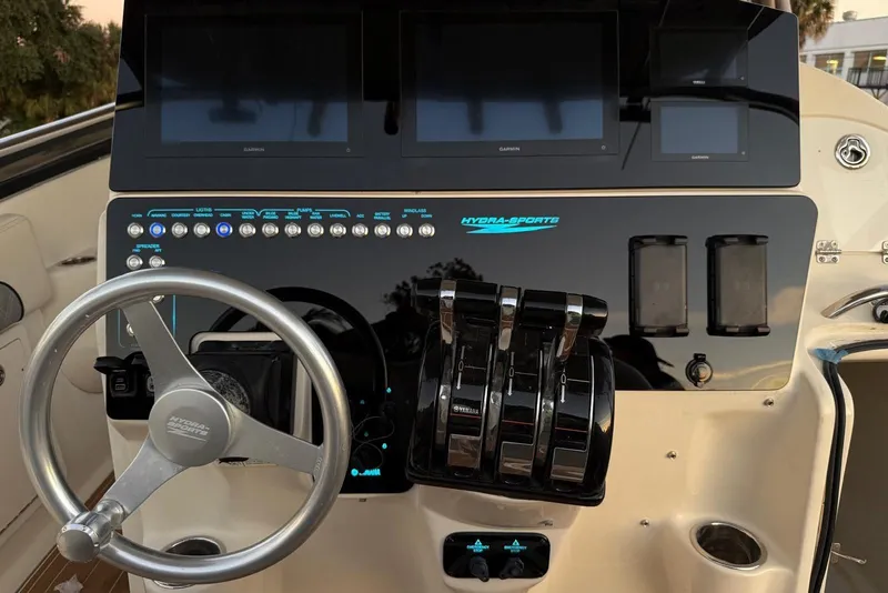 Slide: The Image of 2006 Hydra-Sports Vector 3300 VX helm with steering wheel, controls, and Garmin displays. - 9