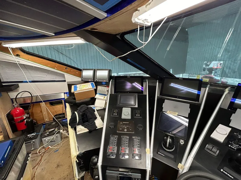 Slide: The Image of Control panel of a 1992 Heesen 141 Motor Yacht, featuring navigation and communication equipment. - 36
