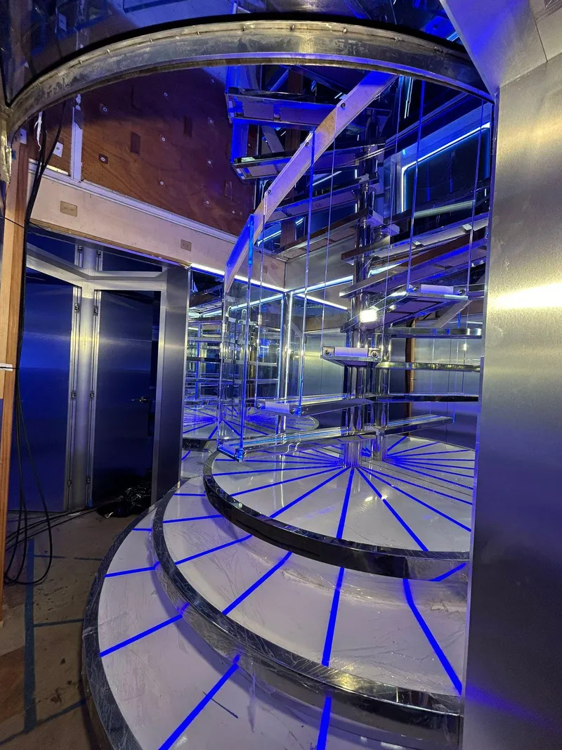Slide: The Image of Luxurious spiral staircase with blue LED lighting on a 1992 Heesen 141 Motor Yacht. - 40