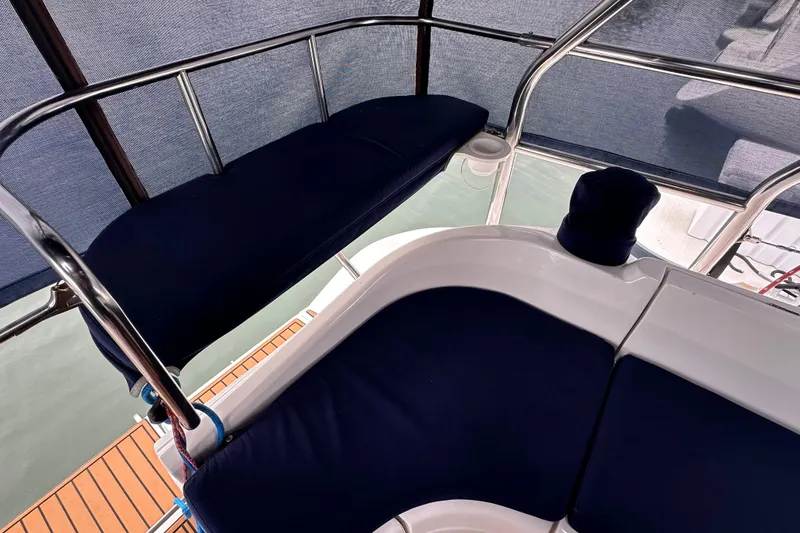 Slide: The Image of Interior view of 2003 Hunter 426 Deck Salon with blue cushioned seating. - 10