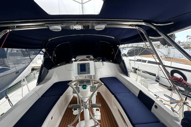 Slide: The Image of Interior view of 2003 Hunter 426 Deck Salon sailboat with blue seating and navigation equipment. - 11