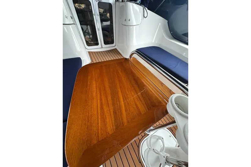 Slide: The Image of Interior of 2003 Hunter 426 Deck Salon with polished wooden table and seating. - 13