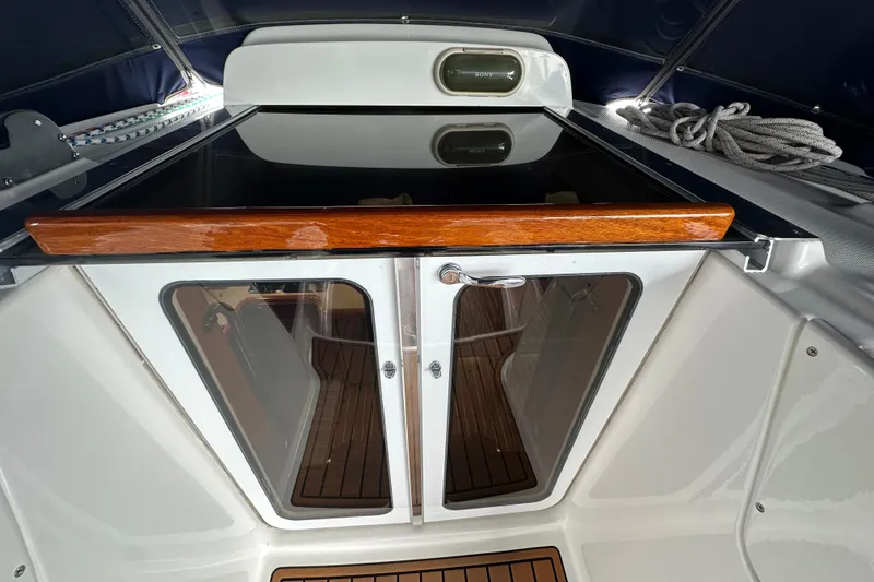 Slide: The Image of Interior view of 2003 Hunter 426 Deck Salon yacht with wooden and glass doors. - 14