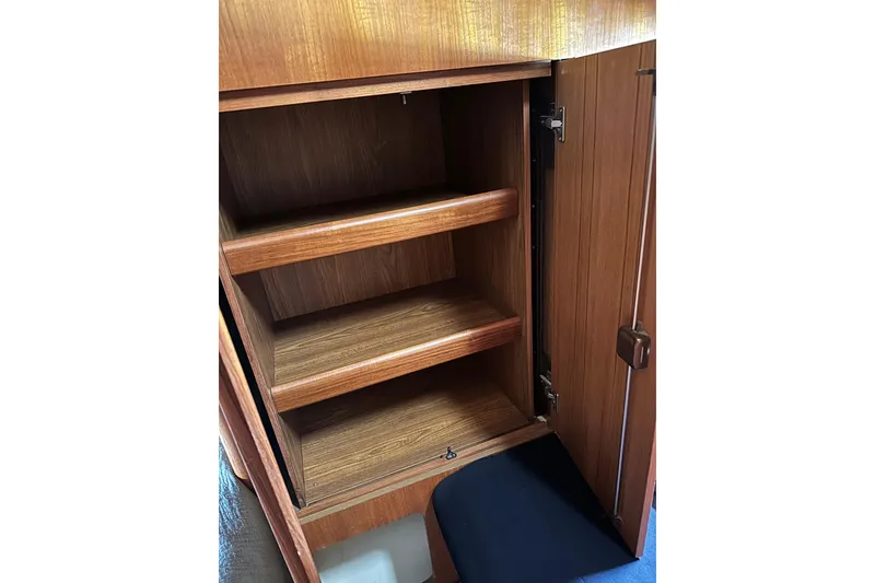 Slide: The Image of Wooden cabinet interior with shelves in 2003 Hunter 426 Deck Salon yacht. - 18