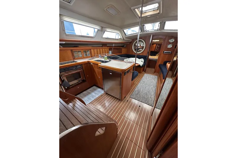 Slide: The Image of Interior of 2003 Hunter 426 Deck Salon yacht with wood finish and modern amenities. - 20