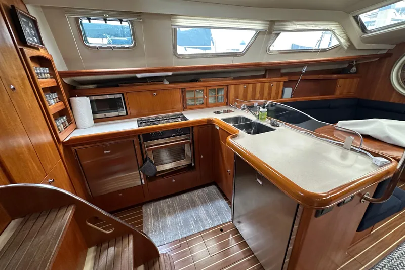 Slide: The Image of Luxurious 2003 Hunter 426 Deck Salon interior with modern kitchen and wooden cabinetry. - 21