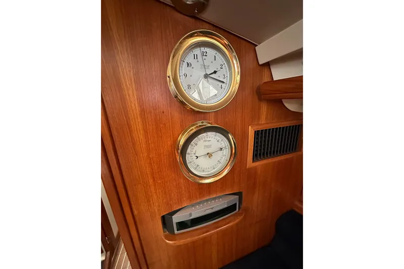 Slide: The Image of Wooden interior of 2003 Hunter 426 Deck Salon with brass clock and barometer. - 25