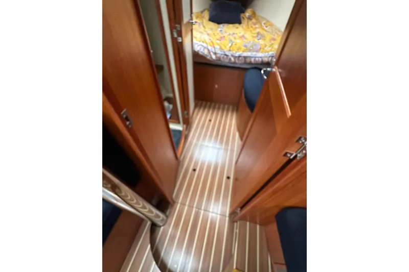 Slide: The Image of Interior of 2003 Hunter 426 Deck Salon with wooden flooring and cozy cabin. - 29