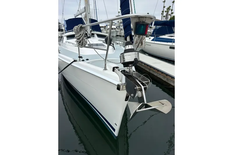Slide: The Image of Hunter 426 Deck Salon 2003 sailboat docked, featuring sleek white hull and anchor. - 3