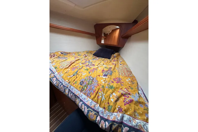 Slide: The Image of Cozy cabin interior of 2003 Hunter 426 Deck Salon with vibrant floral bedding. - 31