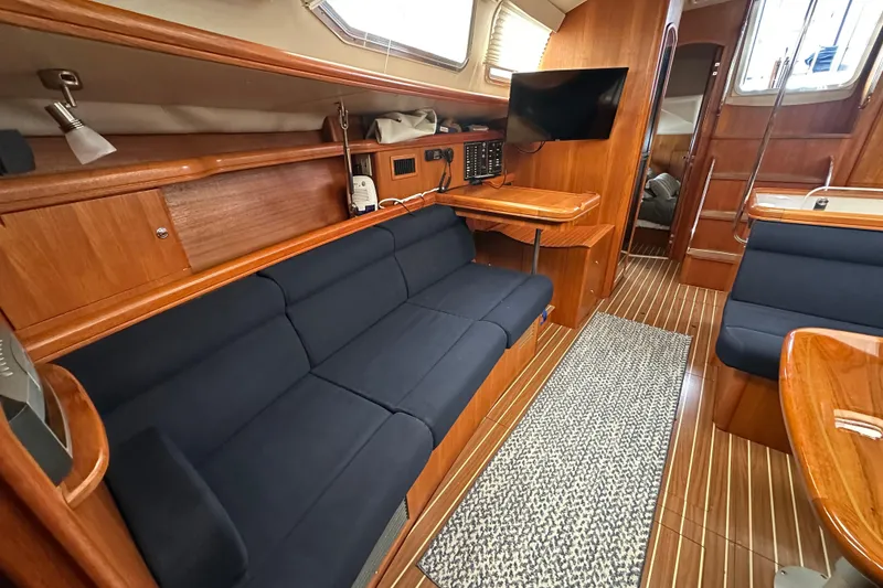 Slide: The Image of Interior of 2003 Hunter 426 Deck Salon yacht with wooden finish and navy seating. - 33