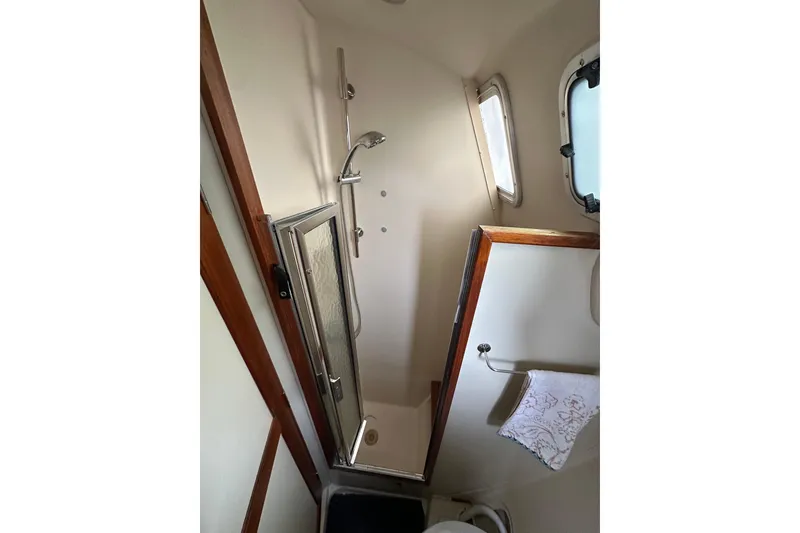Slide: The Image of Shower area in 2003 Hunter 426 Deck Salon yacht, featuring compact design and window. - 34