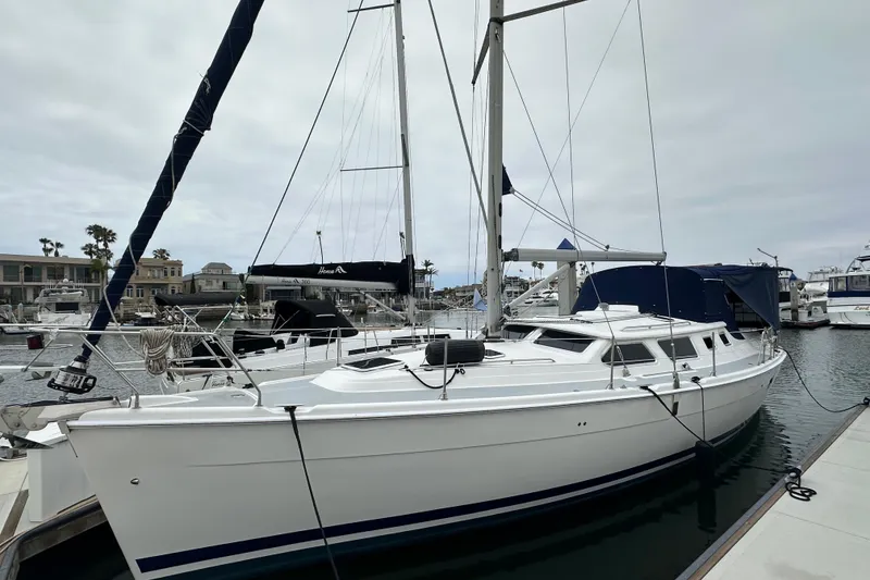 Slide: The Image of Hunter 426 Deck Salon sailboat, 2003 model, docked in a marina with overcast skies. - 41