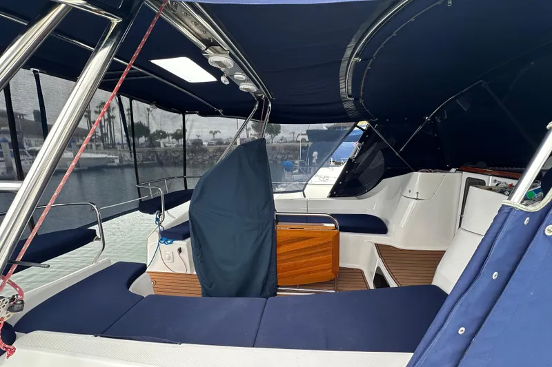 Slide: The Image of Interior view of 2003 Hunter 426 Deck Salon sailboat with blue canopy and seating. - 5