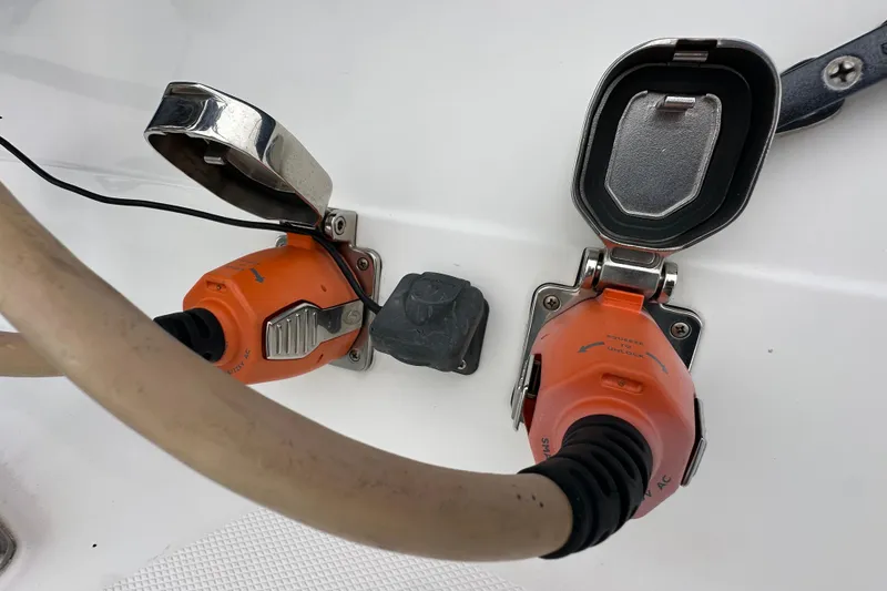 Slide: The Image of Power connectors on a 2003 Hunter 426 Deck Salon yacht, featuring orange plugs and protective covers. - 7