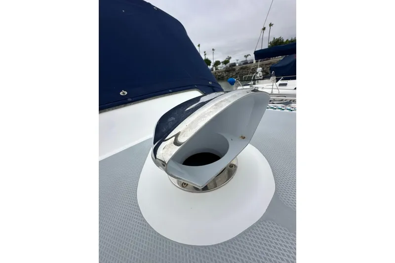 Slide: The Image of Deck detail of a 2003 Hunter 426 Deck Salon sailboat, featuring a chrome vent. - 9
