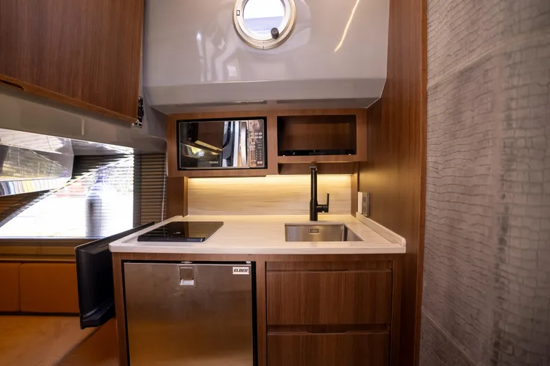 Slide: The Image of Modern kitchen in 2027 Hanover 447 yacht with sleek wood cabinetry and stainless steel appliances. - 9