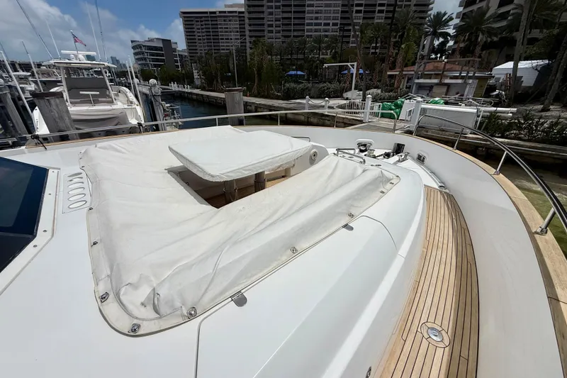 Slide: The Image of Azimut Magellano 66 yacht deck with covered seating area, docked in a marina, 2020 model. - 11