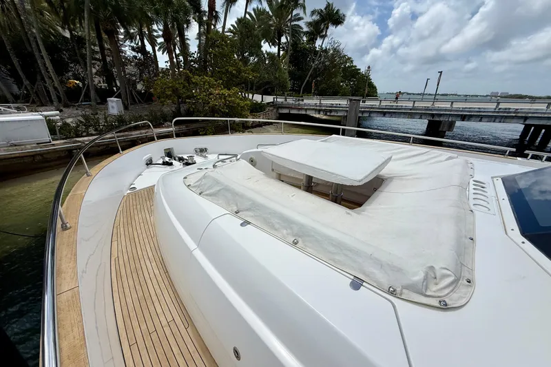 Slide: The Image of Azimut Magellano 66 yacht deck, 2020 model, docked near lush palm trees and waterway. - 14