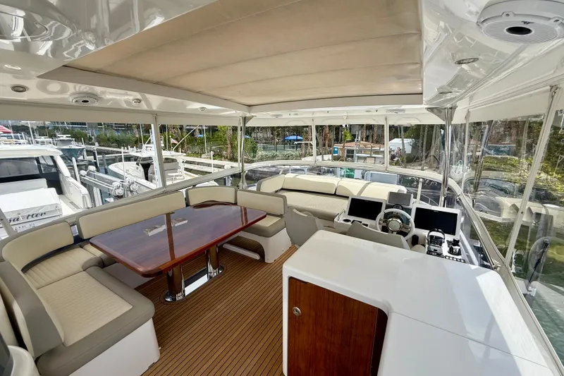Slide: The Image of Luxurious interior of 2020 Azimut Magellano 66 yacht with elegant seating and navigation controls. - 16