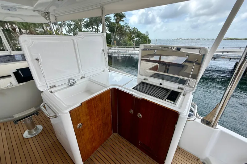 Slide: The Image of Outdoor kitchen on 2020 Azimut Magellano 66 yacht with sink and grill, overlooking water. - 17