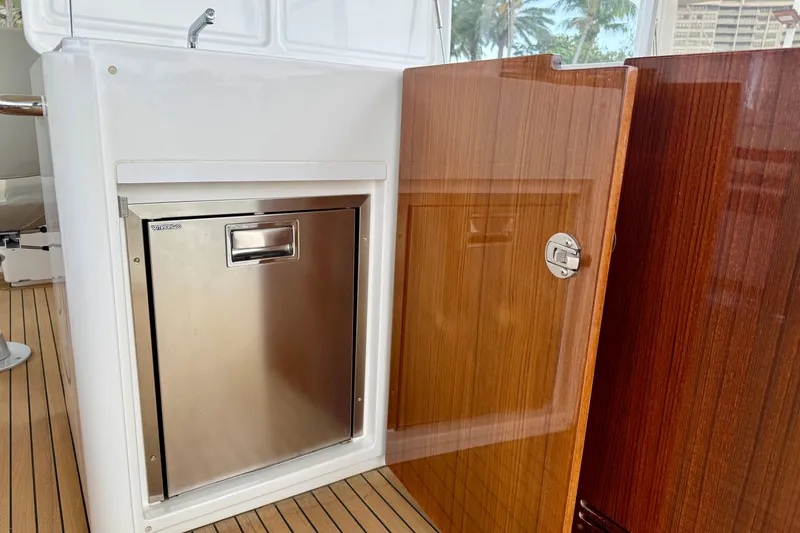Slide: The Image of Stainless steel fridge on Azimut Magellano 66 yacht, 2020 model, with wooden cabinetry. - 18