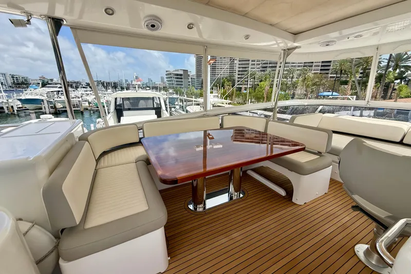 Slide: The Image of Luxurious 2020 Azimut Magellano 66 yacht interior with elegant seating and polished wood table. - 19