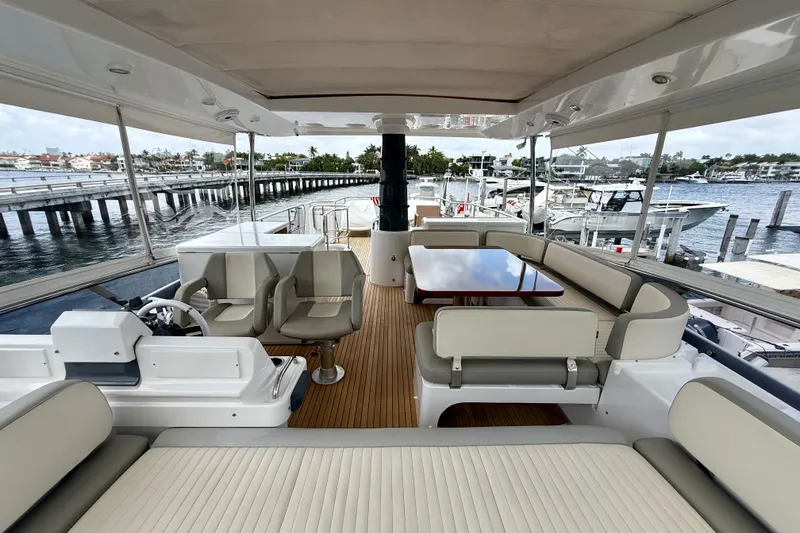 Slide: The Image of Luxurious 2020 Azimut Magellano 66 yacht interior with elegant seating and scenic marina view. - 20