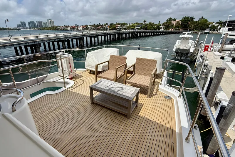 Slide: The Image of Luxurious 2020 Azimut Magellano 66 yacht deck with seating, overlooking marina and cityscape. - 25