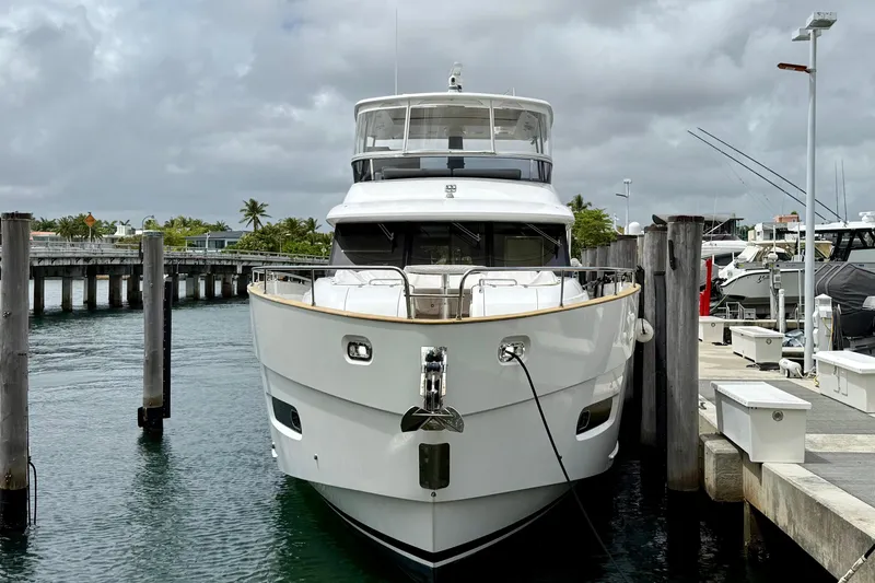 Slide: The Image of Azimut Magellano 66 yacht docked at marina, 2020 model, under cloudy skies. - 3