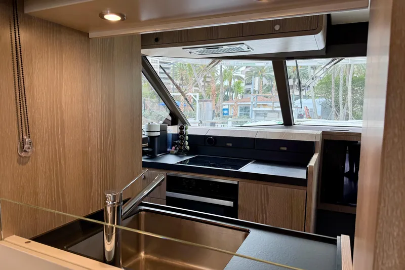Slide: The Image of Modern kitchen interior of 2020 Azimut Magellano 66 yacht with sleek wood finishes. - 31