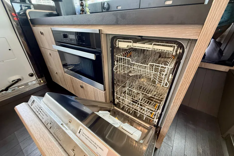 Slide: The Image of Modern kitchen in 2020 Azimut Magellano 66 yacht with open dishwasher and oven. - 34
