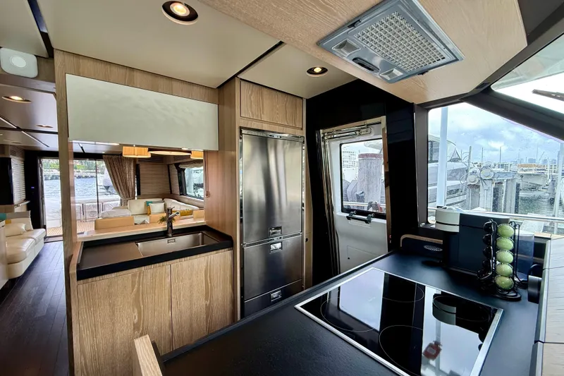 Slide: The Image of Luxurious interior of 2020 Azimut Magellano 66 yacht with modern kitchen and scenic marina view. - 35