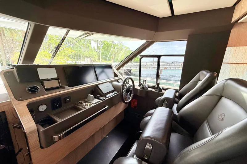 Slide: The Image of Luxurious helm of 2020 Azimut Magellano 66 yacht with leather seats and modern controls. - 37