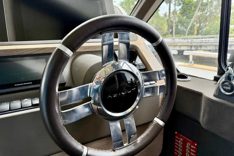 Slide: The Image of Steering wheel of 2020 Azimut Magellano 66 yacht, featuring sleek design and Volvo Penta controls. - 40