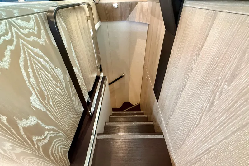 Slide: The Image of Staircase with wooden paneling inside a 2020 Azimut Magellano 66 yacht. - 47