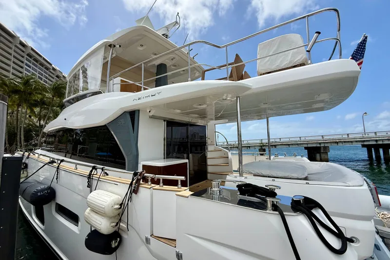 Slide: The Image of Luxury Azimut Magellano 66 yacht docked, showcasing sleek design and spacious deck, 2020 model. - 5