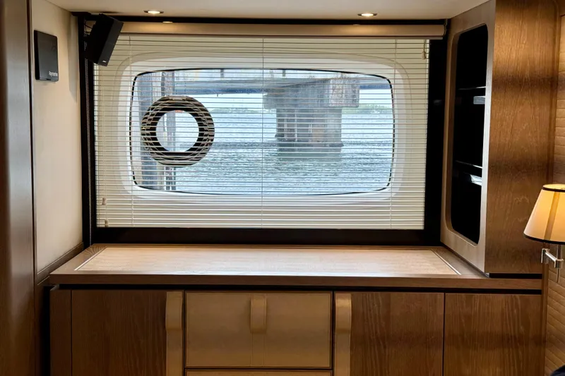 Slide: The Image of Interior of 2020 Azimut Magellano 66 yacht with window view and wooden cabinetry. - 55