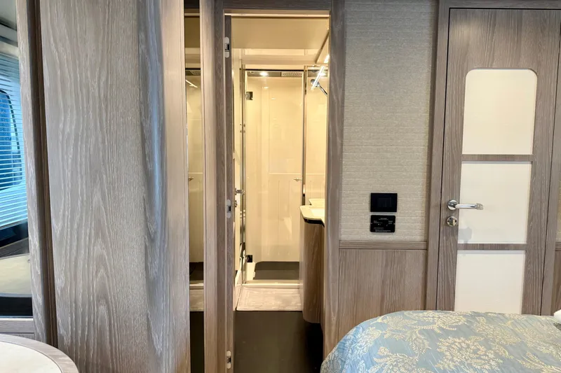 Slide: The Image of Interior of 2020 Azimut Magellano 66 yacht, featuring elegant wood finishes and modern design. - 56