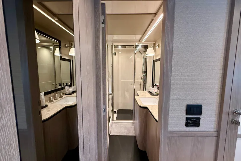 Slide: The Image of Luxurious bathroom interior of 2020 Azimut Magellano 66 yacht, featuring modern fixtures and elegant design. - 57