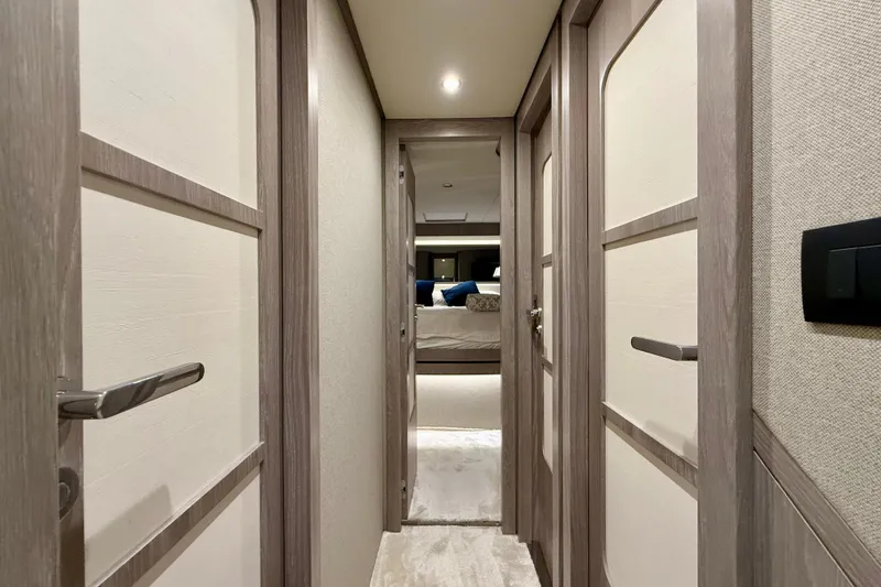 Slide: The Image of Hallway inside 2020 Azimut Magellano 66 yacht, featuring modern wood paneling and elegant design. - 64