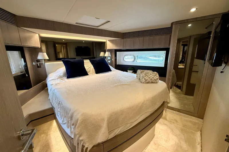 Slide: The Image of Luxurious bedroom interior of 2020 Azimut Magellano 66 yacht with elegant decor and cozy bedding. - 66
