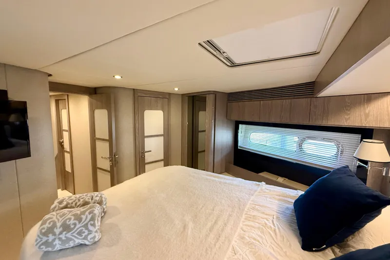Slide: The Image of Luxurious bedroom interior of 2020 Azimut Magellano 66 yacht with modern design and cozy bedding. - 67