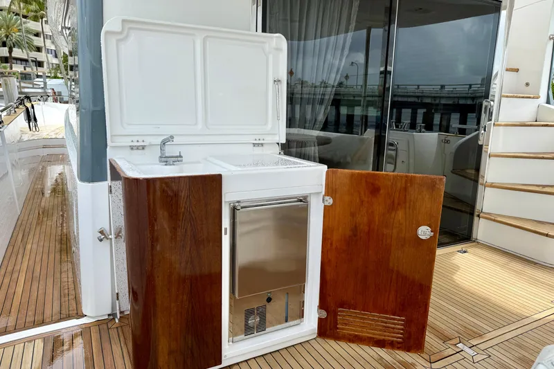 Slide: The Image of Outdoor kitchenette on 2020 Azimut Magellano 66 yacht with sink and wooden cabinetry. - 7