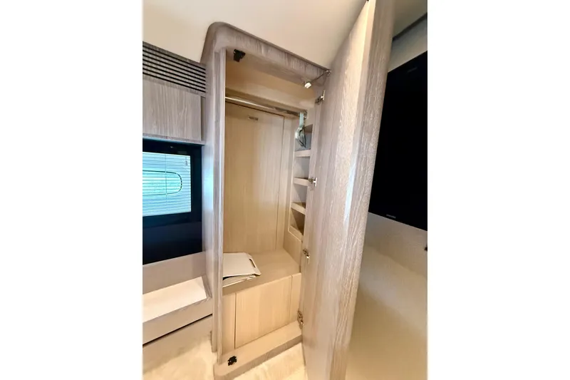 Slide: The Image of Interior view of 2020 Azimut Magellano 66 yacht's wooden wardrobe with shelves. - 71