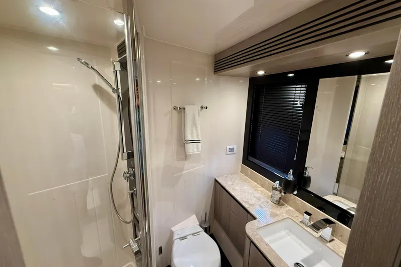 Slide: The Image of Luxurious bathroom in 2020 Azimut Magellano 66 yacht, featuring modern fixtures and elegant design. - 72